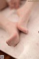 A close up of a person's feet on a table.