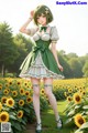 A woman in a green dress standing in a field of sunflowers.