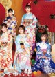 A group of women in kimonos posing for a picture.